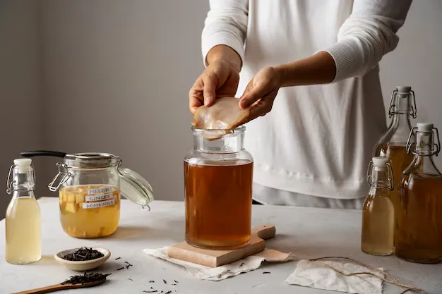 hands making kombucha