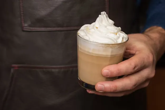 a person holding a cup of mocha