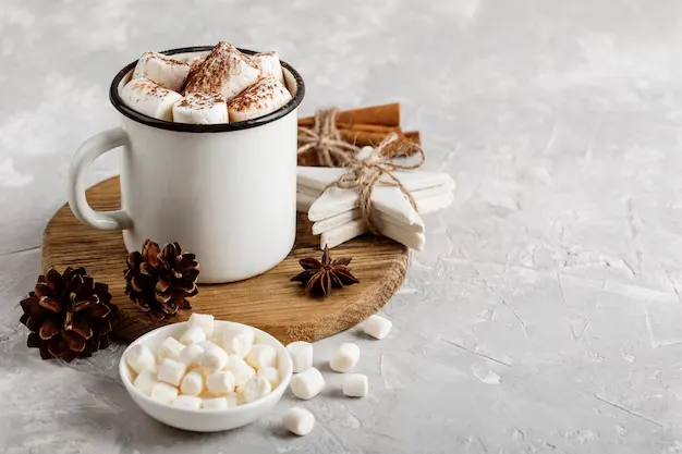 hot cocoa with marshmallows in a white cup.