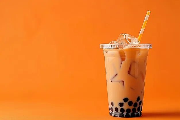 a glass of bubble tea with orange background.
