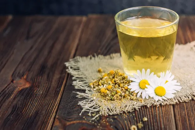 chamomile tea placed on a wooden table.