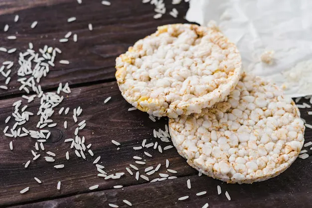 rice cakes with rice grains on wooden surface