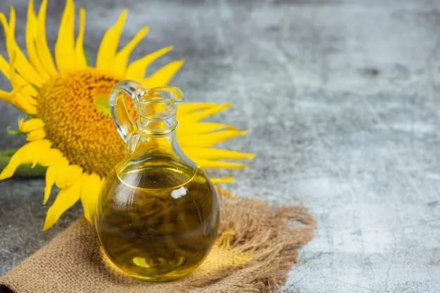 sunflower oil in a glass jar with sunflower at its back